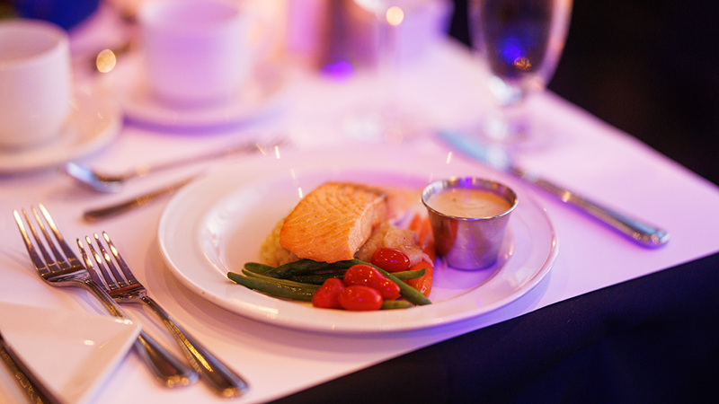 A well-presented plate of salmon accompanied by a portion of fresh market vegetables.