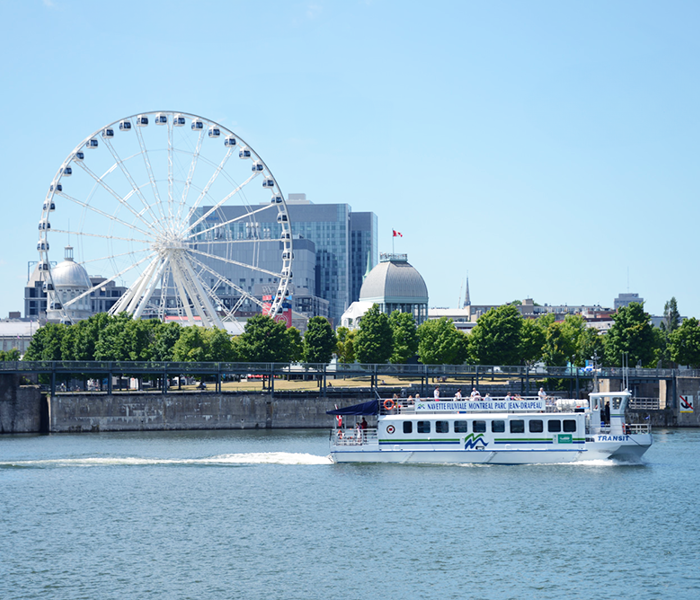 The river shuttle on the St. Lawrence with Montreal's Ferris wheel in the background.